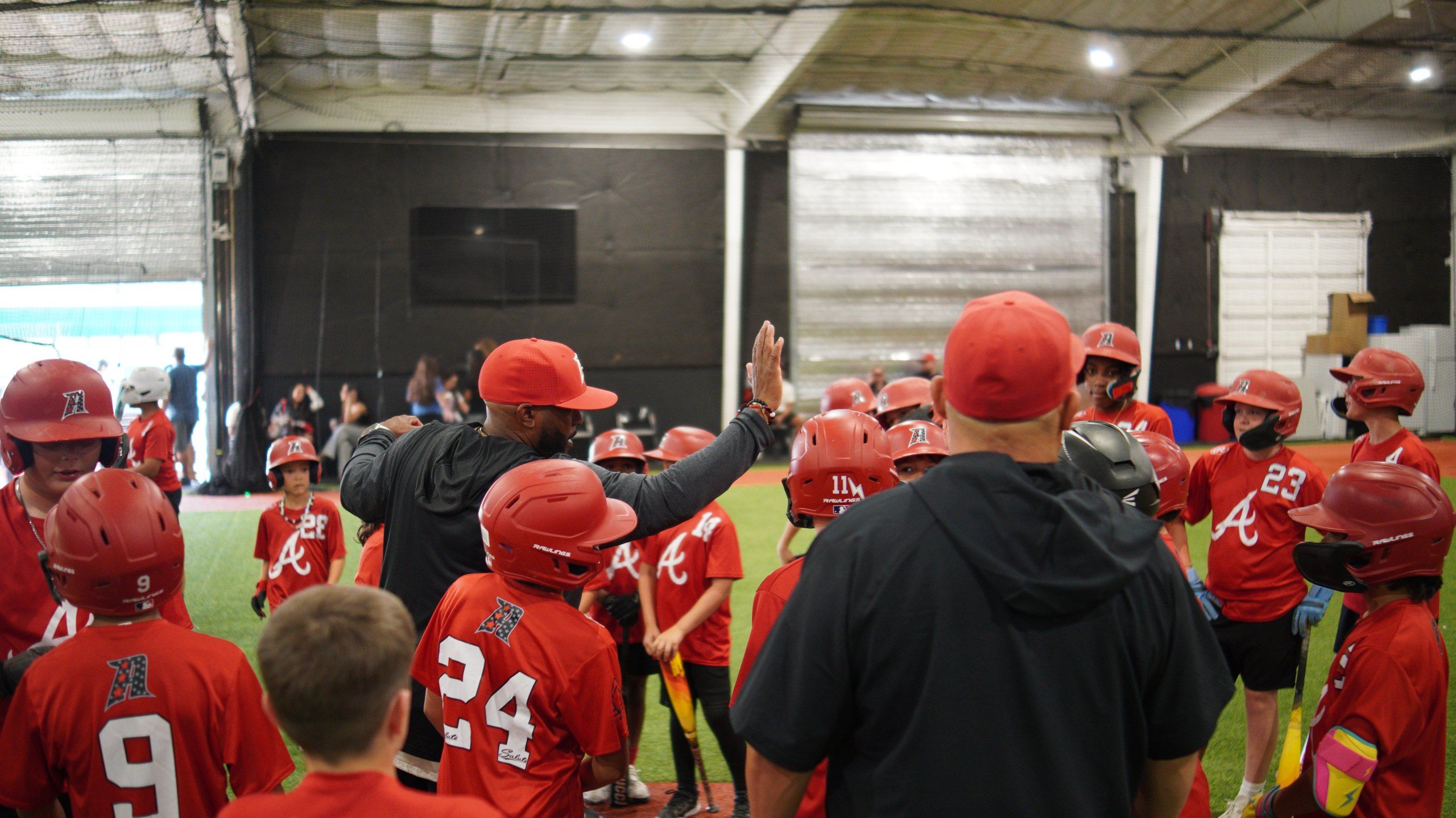 An Admirals coach high-fives a player as the team gathers around him on the turf at The ACE in Vacaville