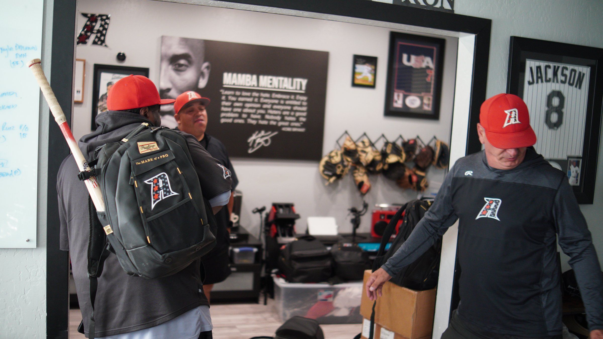 An Admirals coach talks with a player and his gear bag in the trophy room at The ACE in Vacaville