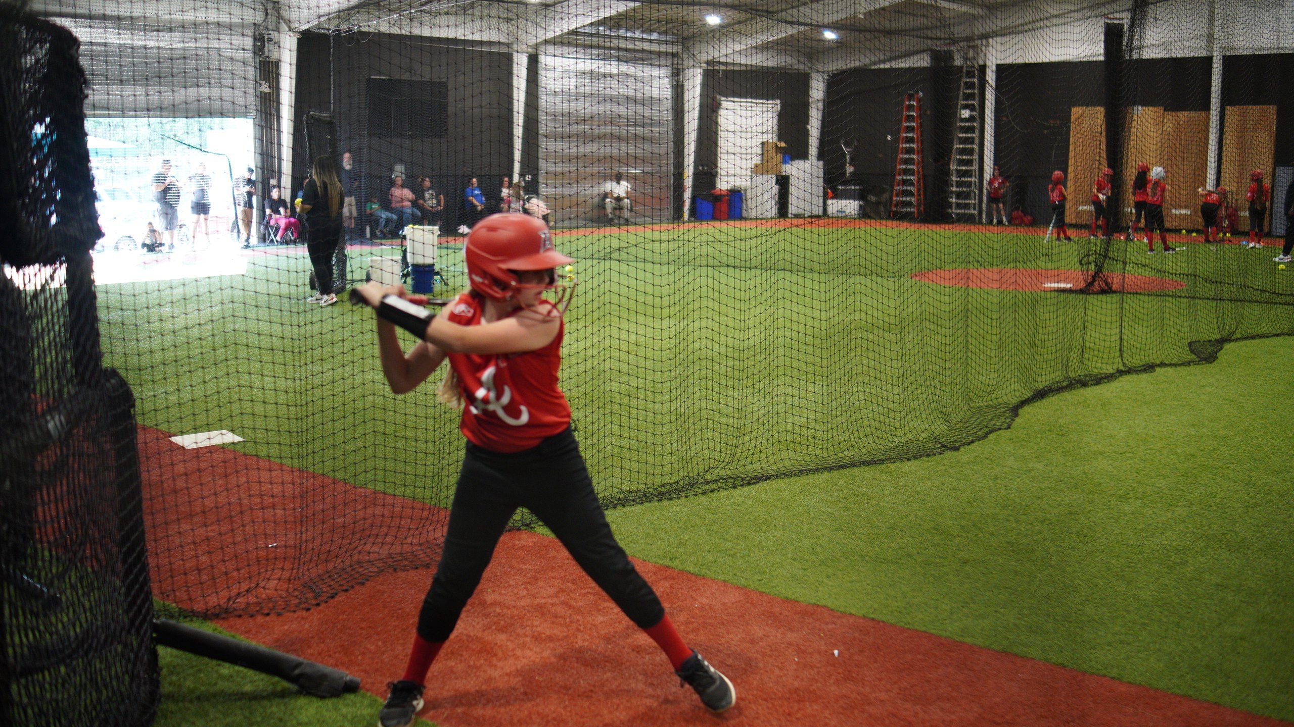 A Lady Admirals softball player takes a swing during front toss at The ACE in Vacaville