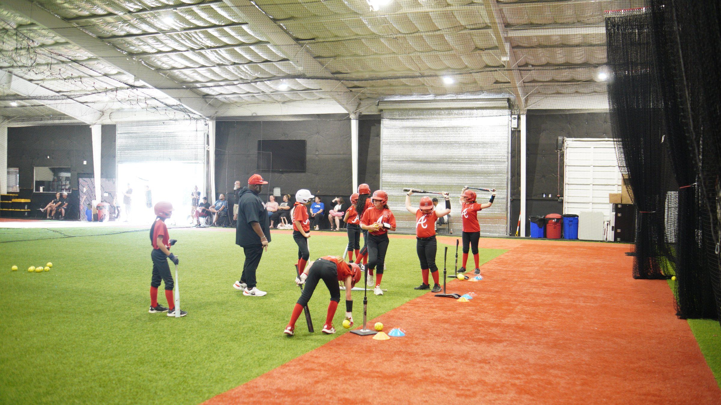 Lady Admirals softball players work through tee drills with their coach at The ACE in Vacaville